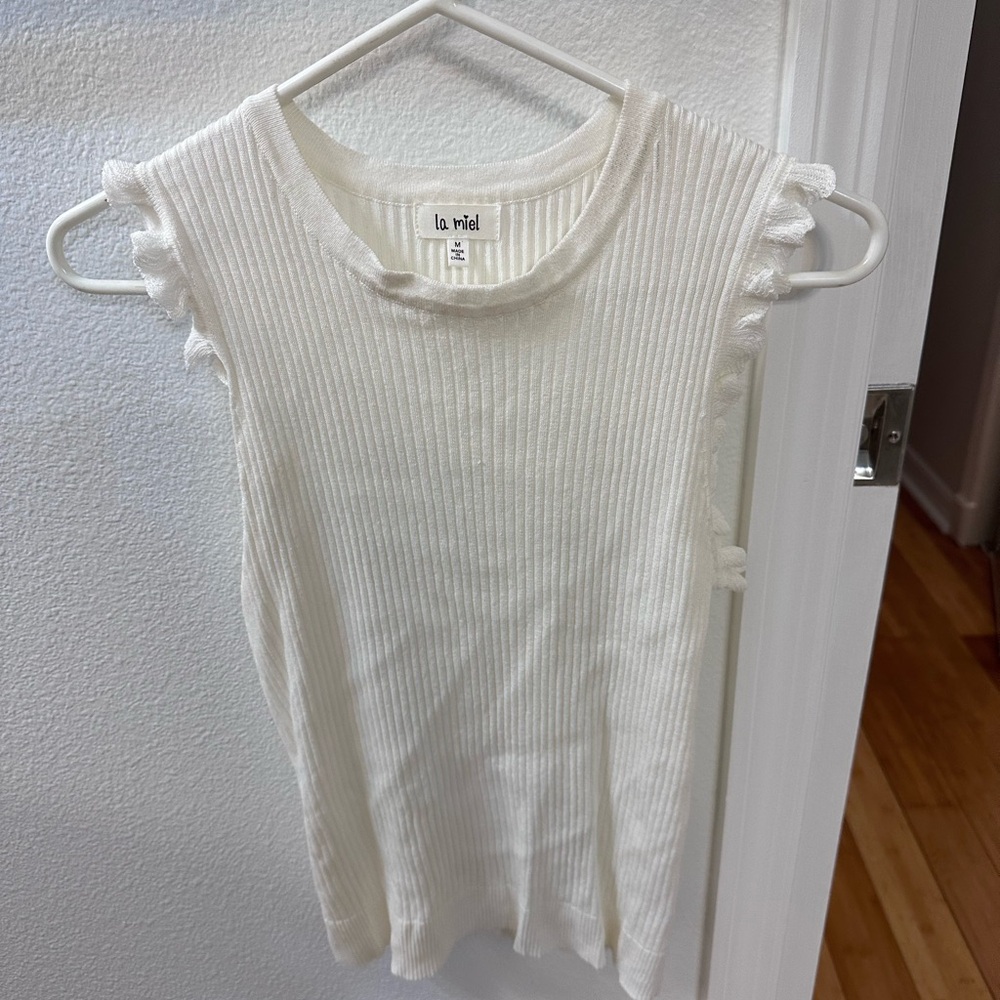 White super cute Sleeveless top with ruffles . Size M